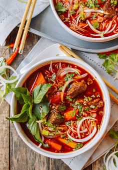 two bowls of soup with meat and vegetables