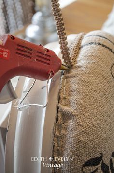 a red blow dryer sitting on top of a pillow