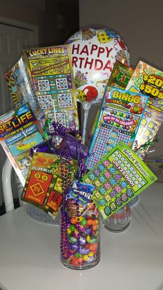 a vase filled with lots of candy on top of a table