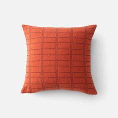 an orange pillow on a white background