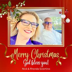 a man and woman are sitting in a car with christmas decorations on the front window