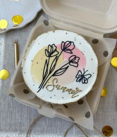 there is a decorated cake in the shape of a flower on top of some paper plates