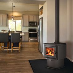 Napoleon S20 Wood Stove with Pedestal offers a premium wood stove insert for your home. The unit's contemporary design offers an attractive appearance, while EPA 2020 certification ensures low emissions. A precision "Easy Glide" ash drawer with removable ash pan offers easy cleanup, while a cast door with hidden hinges and an extra large glass viewing area offer attractive views from anywhere in the room. A ceramic fiber baffle system rounds out an impressive design for an impressive unit capable of upgrading any space. UP TO 65,000 BTU’S • 1.9 CU. FT. FIREBOX CAPACITY • BURN TIME: 8 HOURS Overall Dimensions - 34.25" x 26" x 20.5" (Height, Width, Depth) Glass Dimensions - 15.625" x 9.75" (Width, Height) Recommend Blower Kit Ash Pan Optional - Click here Optional Outside air kit Features He Free Standing Wood Burning Stove, Napoleon Fireplace, Stoves For Sale, Heat Recovery Ventilation, Cord Wood, Modern Flames, Hidden Hinges, Ceramic Fiber, Steel Railing