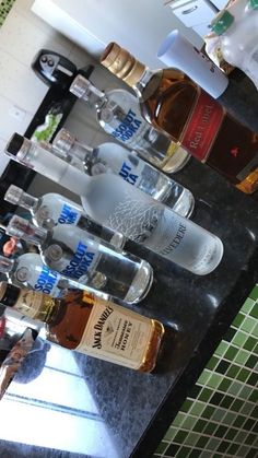 several bottles of alcohol lined up on a counter