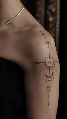 a woman's arm with a tattoo on it that has an arrow and stars