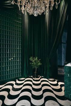 a black and white floor with a chandelier