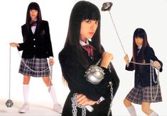 two girls dressed in school uniforms and holding balls, chains, and whipsticks