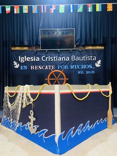 a large display with ropes on it in front of a blue curtain