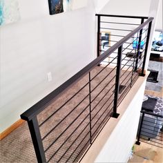 the stair railing is made of metal and wood