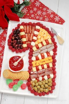 a platter filled with cheese, crackers and fruit