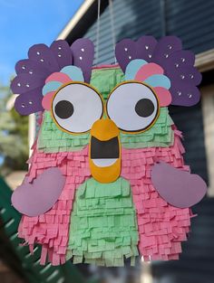 a paper owl hanging from a string