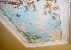 the ceiling is decorated with birds and trees