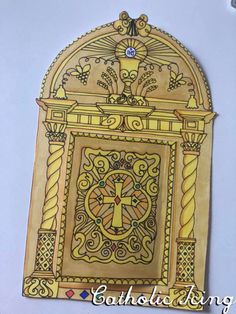 an intricately designed wooden plaque with a cross on it