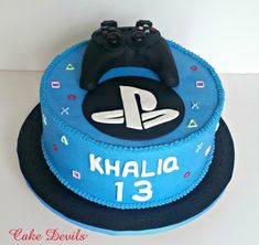 a blue birthday cake with a video game controller on it's top and the number 13