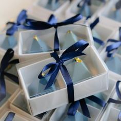 several white boxes with blue ribbons tied around them