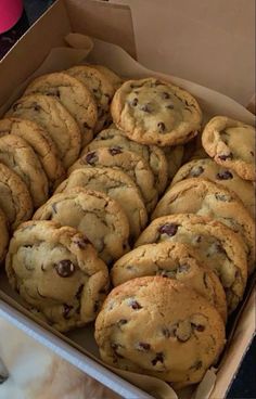 a box full of chocolate chip cookies sitting on a table