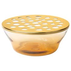 a yellow glass bowl with holes on the side and a gold strainer in front