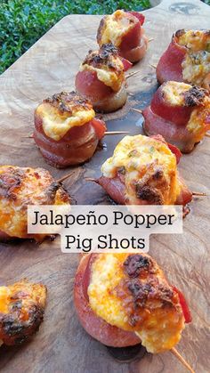 some food is sitting on top of a cutting board with the words jalapeno popper pig shots