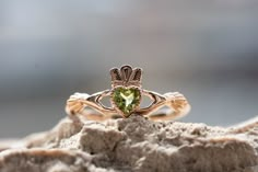 The Peridot Claddagh ring. Traditional Irish ring. Sign of love, loyalty, and friendship. The ring, as currently known, was first produced in the 17th century. Piece of our Celtic Jewelry collection. Best match of Peridot Promise Ring. : Main gemstone: Peridot Metal: Gold 585o (14K) Average weight: 2,7 gr. : * If desired, we can replace the main gem with any of the following: Amethyst, Alexandrite, Citrine, Emerald, Garnet, London Blue Topaz, Sky Topaz, Peridot, Smoky Quartz, Sapphire, Ruby. * I Emerald Claddagh Ring, Chinese Mirror, Claddagh Wedding Ring, Irish Engagement Rings, Basic Wedding, Claddagh Engagement Ring, Chic Nostalgia, Irish Ring, Sign Of Love