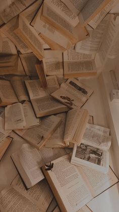 many open books are scattered on the floor