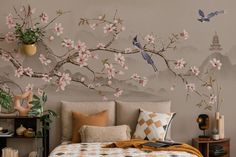 a bedroom decorated with flowers and birds on the wall