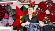 a woman is smiling as she sews some clothes