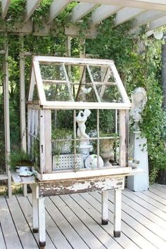 an old birdcage sitting on top of a wooden deck