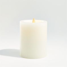 a white candle with a yellow wax inside