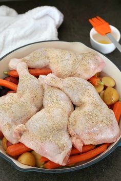 chicken, carrots and potatoes in a skillet with seasoning on top for garnish