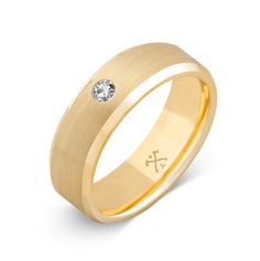 a yellow gold wedding ring with a diamond in the center