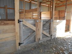 the inside of a barn with wooden doors