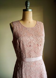 A soft muted blush pink shade dress in beautiful guipure lace Fully lined Zipper back Grosgrain ribbon at the waist Lined Tulle insets at the hem of skirt Reminiscent of a 50s dress Label: BCBG Women's US size 10 Measurements: 19 inches armpit to armpit laying flat 15 1/2 inches across at the waist laying flat 40 inches from back of collar to hem of dress Excellent condition Sleeveless Bridesmaid Lace Dress With Lace Back, Sleeveless Lace Back Dress For Bridesmaids, Sleeveless Delicate Lace Dress For Wedding Guest, Sleeveless Lace Dresses For Wedding Guests, Feminine Sleeveless Bridesmaid Dress For Wedding, Blush Sleeveless Wedding Dress, Fitted Pink Bridesmaid Dress With Lace Bodice, Sleeveless Lace Dress With Lace Back For Wedding, Elegant Lace Dress With Lace Back For Garden Party