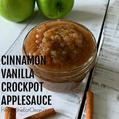 cinnamon vanilla crockpot applesauce in a glass jar with cinnamon sticks next to it