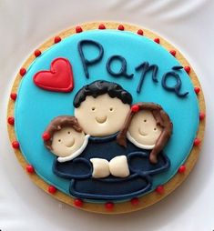 a decorated cookie with the words paro and two children on it's face