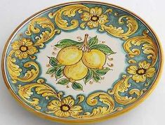 a yellow and green plate with lemons on it