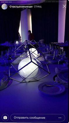 a room filled with lots of tables covered in plates and wine glasses on top of it