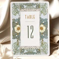 a table number card with flowers on it