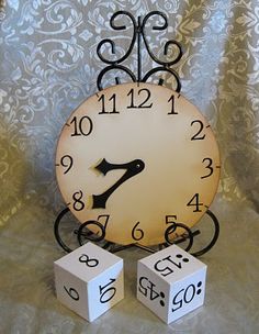 a clock and two dices sitting on a table