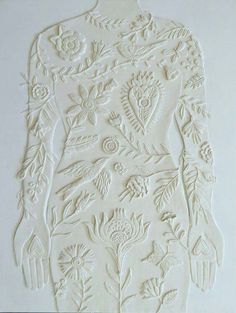 an intricately carved piece of paper with flowers on it