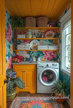 a washer and dryer in a small room with colorful wallpaper on the walls