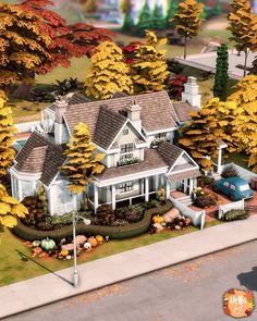 an aerial view of a large house surrounded by trees and bushes with fall foliages