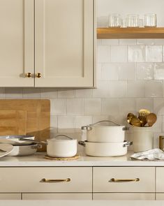 pots and pans are sitting on the kitchen counter