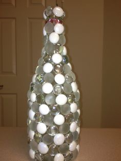 a glass christmas tree with white and gray balls