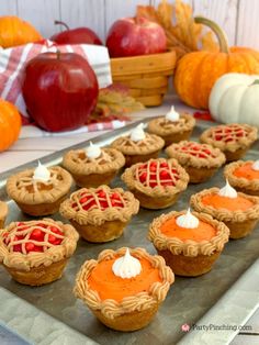 pumpkin pie cupcakes on a tray with apples in the background