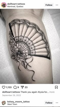 a woman's arm with a fan tattoo on the left side of her thigh