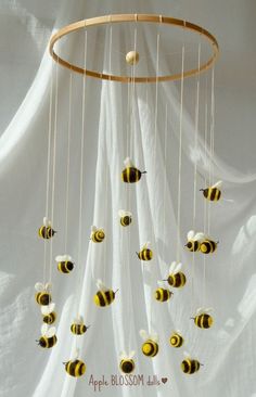 a mobile made to look like bees hanging from the ceiling with strings and balls in it