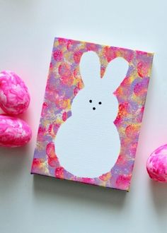 an easter card with pink and yellow eggs next to it