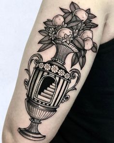 a woman's arm with a vase and flowers on it