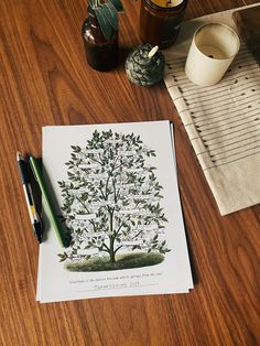 a paper with a tree drawn on it next to a pen and some other items