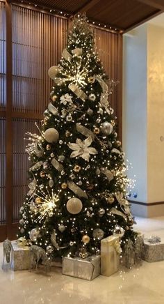 a decorated christmas tree with presents under it